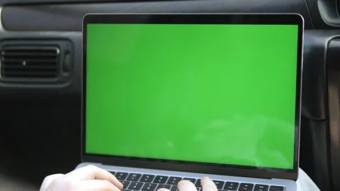 Someone uses laptop with green screen inside vehicle 動画素材 340953923