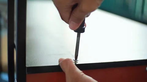 Someone using a screwdriver to assemble Stock Footage 325352879