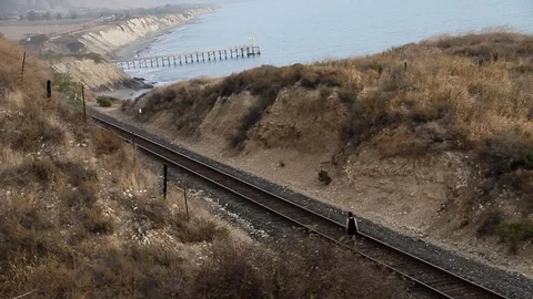 Someone walking along railroad tracks Stock Footage 83134877