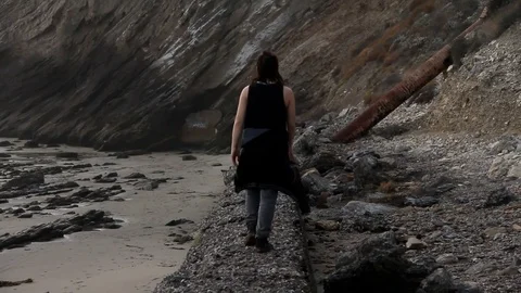 Someone walking along a wall edge Stock Footage 83161692