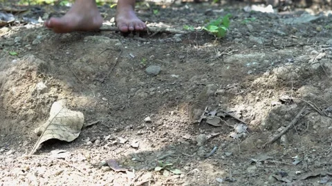 Someone walking barefoot on dry ground Stock Footage 206272094