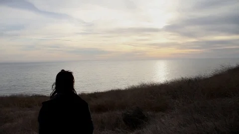 Someone walking down to the ocean Stock Footage 83137922