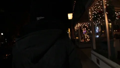 Someone walks down empty street on Xmas eve Stock Footage 83282070
