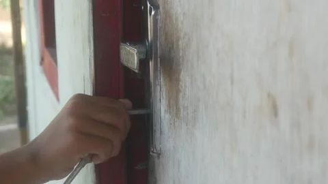 Someone was inserting a key into the lock of a wooden door Stock Footage 332866809