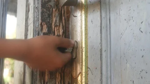 Someone was inserting a key into the lock of a wooden door Stock Footage 332866818