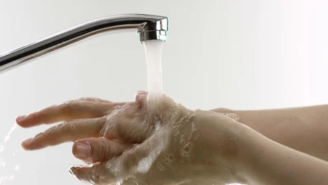 Someone washes his hands under the tap, white background Stock Footage 111532668