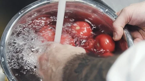 Someone washing red tomatoes. Stock Footage 113322399