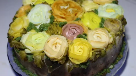 Someone will remove the flower from the cake. Imitations of handmade roses and R Stock Footage 143675376