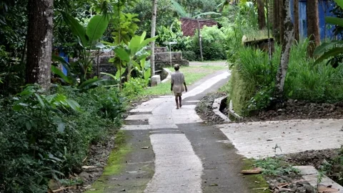 Someone's activity is walking barefoot and carrying a sickle Stock Footage 237789992