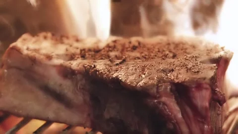 Someone's cooking meat on fire Stock Footage 130988706