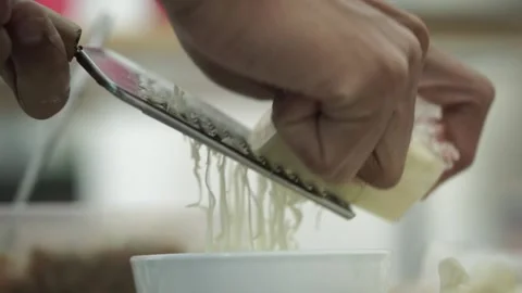 Someone's hand is grating cheese Stock Footage 261247657