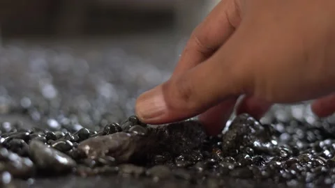 Someone's hand is touching the surface of the pebbles Stock Footage 207471786