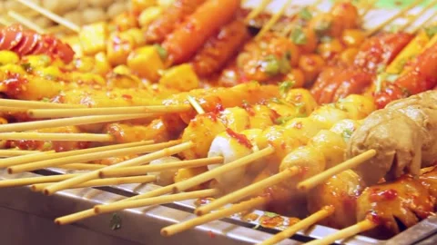 Someone's hands are grilling meatballs on a charcoal grill Stock Footage 332899873