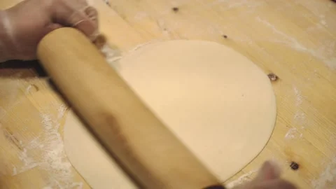Someone's making dough on a wooden table. Stock Footage 132310461