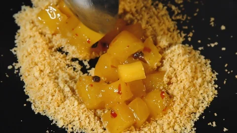 Someone's putting pieces of pineapple on the breadcrumbs. Stock Footage 113175557