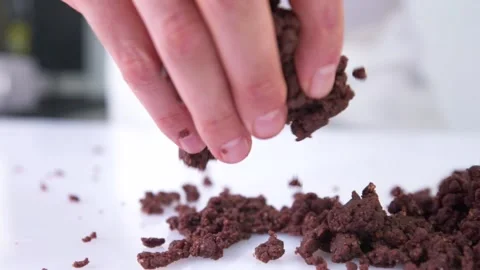 Someone's throwing chocolate on a white table. Stock Footage 130853579