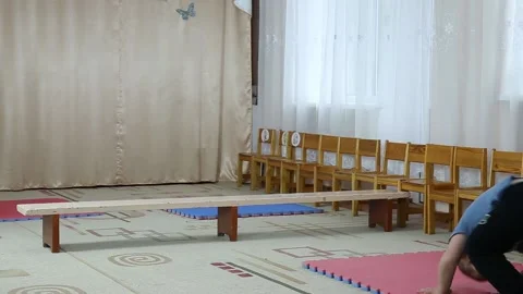 A somersault and a jump through the bench in the performance of a small athlete Stock Footage 109404588