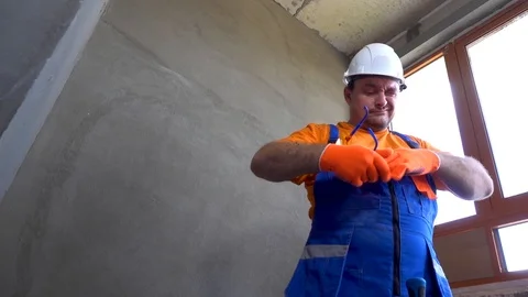 Something fell into the eye of a young worker, not observing the safety rules Stock Footage 115439288
