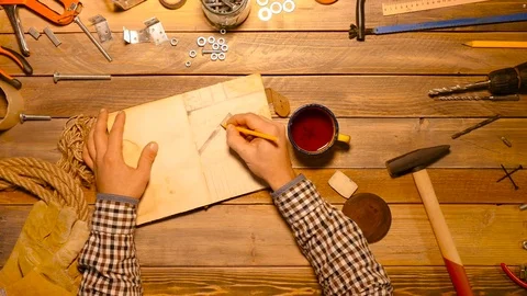 Something going wrong. Craftsman spilled tea on the work table. Top view. Stock Footage 70643459