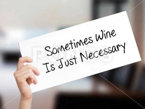 Sometimes Wine Is Just Necessary Sign on white paper. Man Hand Holding Paper Stock Photos