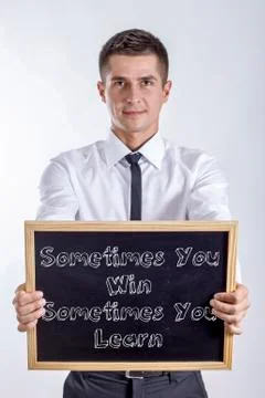 Sometimes You Win Sometimes You Learn - Young businessman holding chalkboar.. Stock Photos