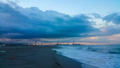 A somewhat blurry picture captures a cloudy sky looming over a serene lake,.. Stock Photos
