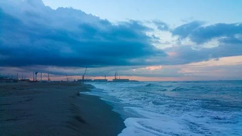 A somewhat blurry picture captures a cloudy sky looming over a serene lake,.. Stock Photos