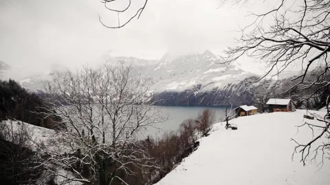 Somewhere in Swiss Alps there is small village with beautiful lake surrounded Stock Footage 259210698