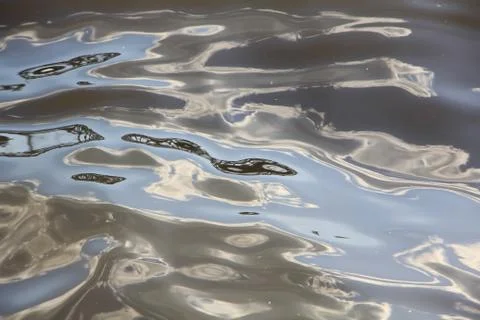 Somewhere turned colored waves on the surface of the water Stock Photos