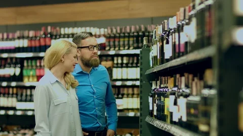 A sommelier couple chooses a wine at the request of their client Stock Footage 93736343