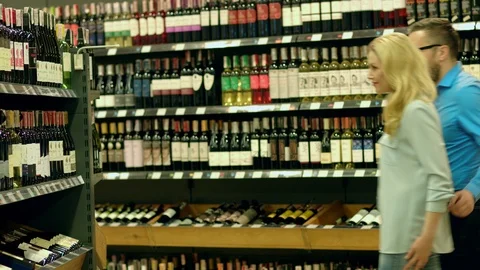 A sommelier couple chooses a wine at the request of their client Stock-Footage 93736412