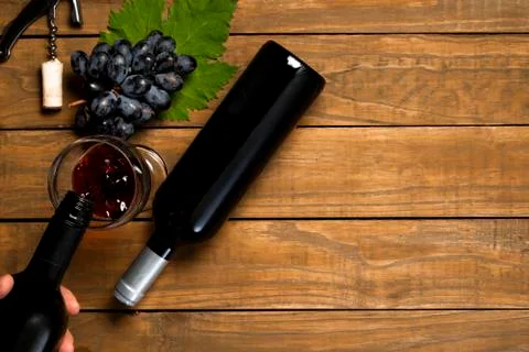 Sommelier serving wine. Grapes leaf opener of corks and wine claw on wooden b Stock Photos