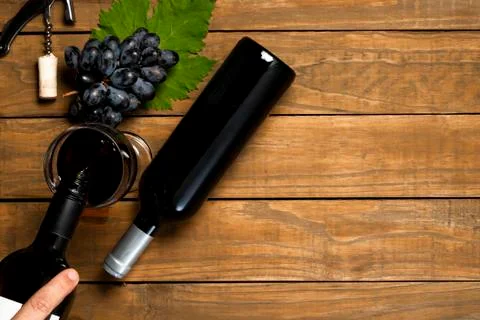 Sommelier serving wine. Grapes leaf opener of corks and wine claw on wooden b Stock Photos