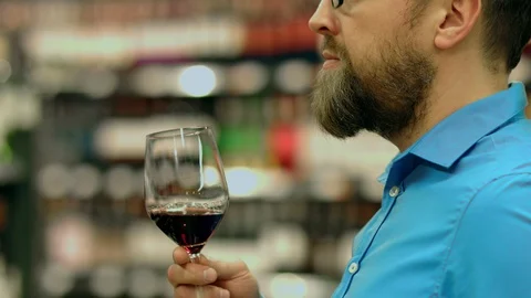 A sommelier tastes red wine at the request of client Stock Footage 93736454