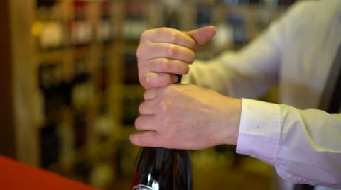 Sommelier uncorks a bottle of sparkling wine in a wine cellar. Stock Footage 63859155