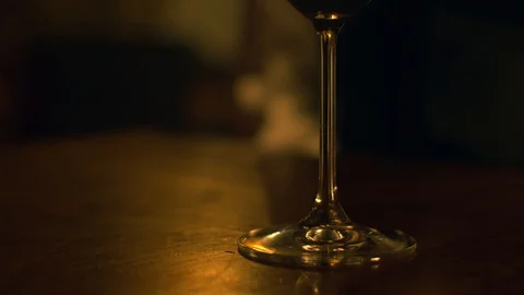 A sommelier in white gloves sits at a table with a glass of wine and takes a gla Stock Footage 129556838