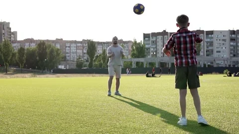 Son and dad play with a ball on the lawn. Active happy family having fun playing 스톡 동영상 281145012