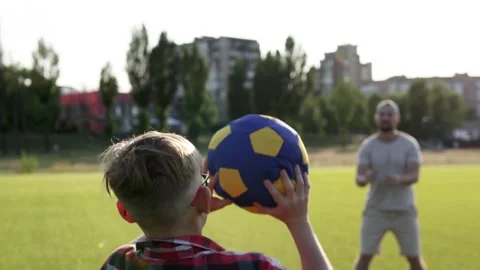 Son and dad play with a ball on the lawn. Active happy family. Stock Footage 281145013