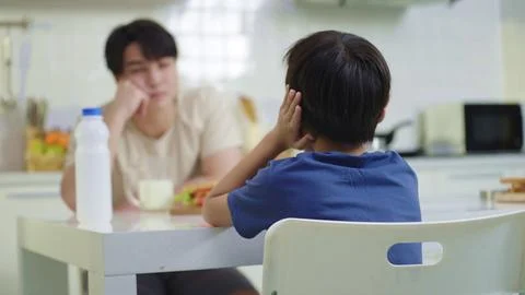 Son closing ears while father scolding. Child avoid ignore listening to father 写真素材