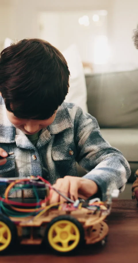 Son, dad and high five with toy car for engineering or remote control vehicle in Stock Footage 339131590