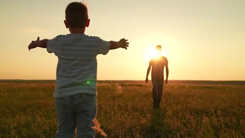 Son dad having fun playing ball on green grass. Family kid sport. Child son play Stock Footage 308335814