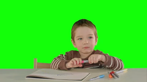A son drawing at the table at home on a Green Screen Stock Footage 55883369