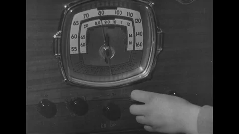 Son of farmer tune radio at home - 1940 Stock Footage