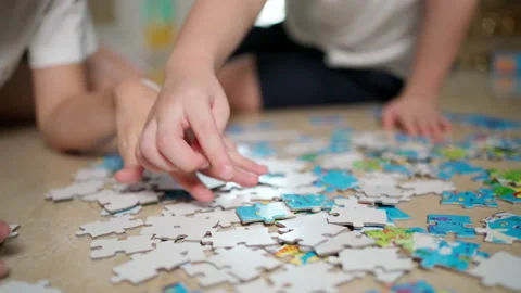 Son finding part of jigsaw puzzle Stock Footage 155094302