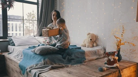 Son give a present box to his mom and open it together Stock Footage 121972570