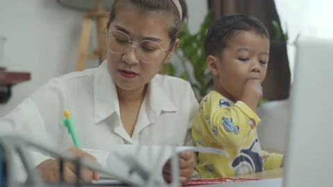 The son Interferes With Her Mother's Work. Stock Footage 157971560