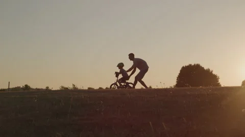 Son Learning To Ride Bike With Dad Stock Footage 208770416