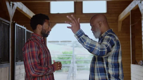 Son Listens While Father Shares Discussion Inside Barn Stock Footage 270399653