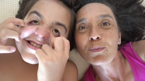 Son making horror faces while shooting Selfie with mother Stock Footage 315222895