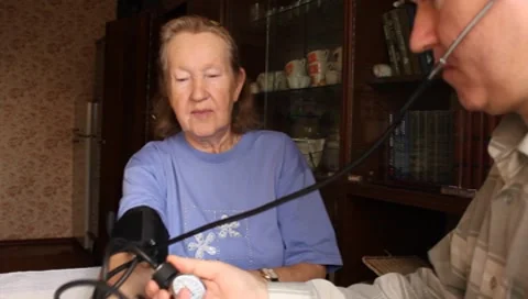 Son, measures the blood pressure in elderly mother Video stock 8959967